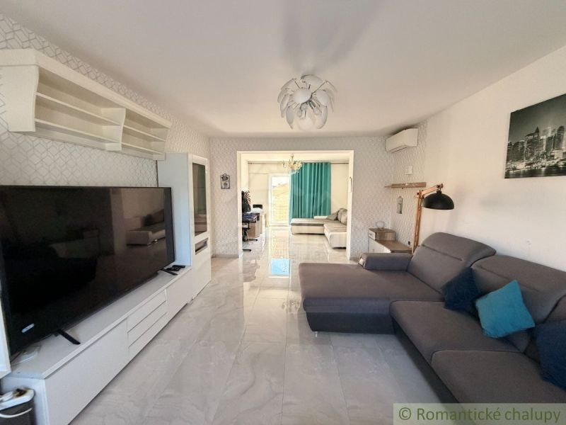 Living room in a family house with a sofa, television, and spacious layout.