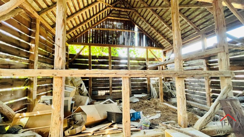 The interior of an older wooden family house with clutter and building materials.