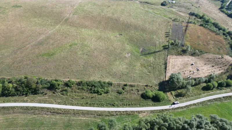 Aerial view of agricultural and forest lands around Plaveč with a road.