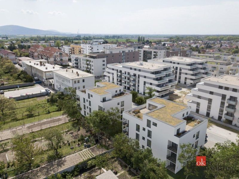 A view of apartment buildings on Cementárenská Street in Stupava with plenty of greenery.