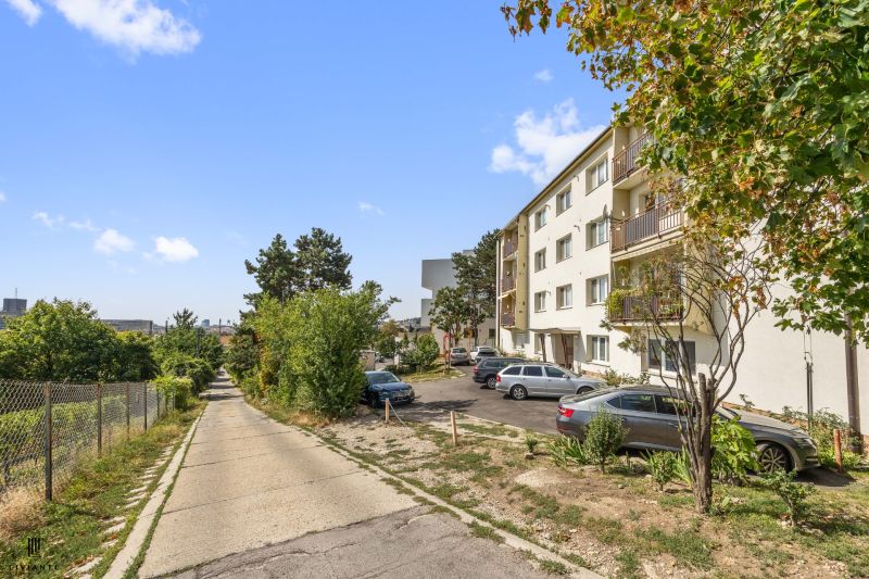 Apartment building on Matúškova Street, Bratislava - Nové Mesto, surrounded by greenery and parking.