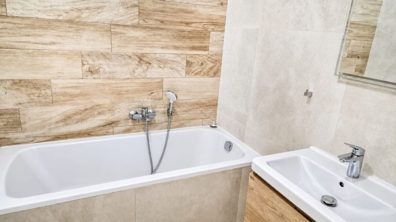 Bathroom with a bathtub and shower, 2-room apartment, tiles with wood decor.