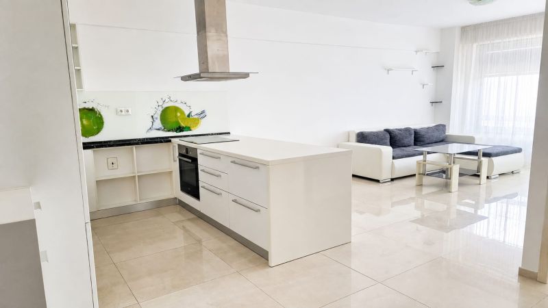 A spacious kitchen connected to the living room, light tones, and stylish graphic details.