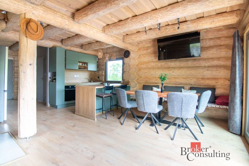 A cozy kitchen in a family house with a wooden decor floor and wooden walls.