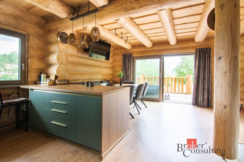 Interior of a family house with wooden decor and a kitchen island.