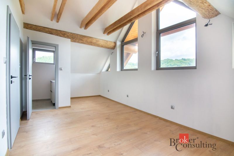 A floor with a wooden decor and beams in the attic room of a family house.