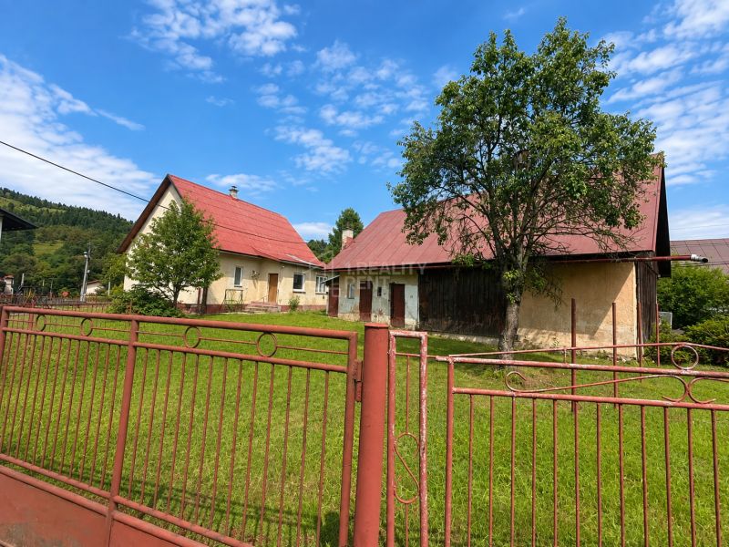 A family house in Oščadnica on Oščadnica street with a red roof and a large garden.
