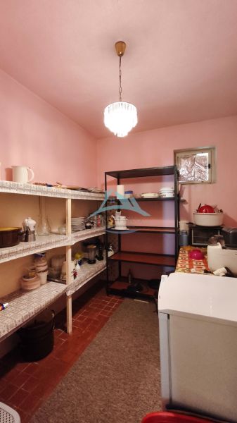 A pantry in a family house with shelves for food and accessories.