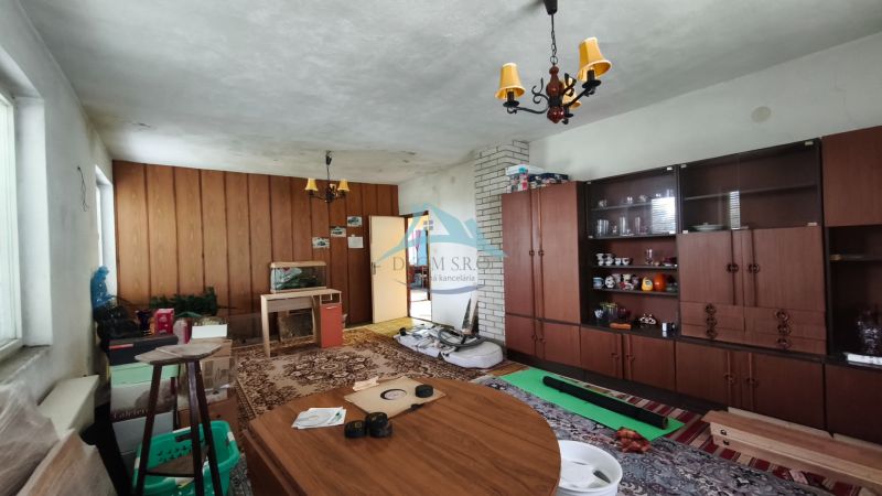 Living room in a family house with furniture and a carpet, wooden decor flooring.