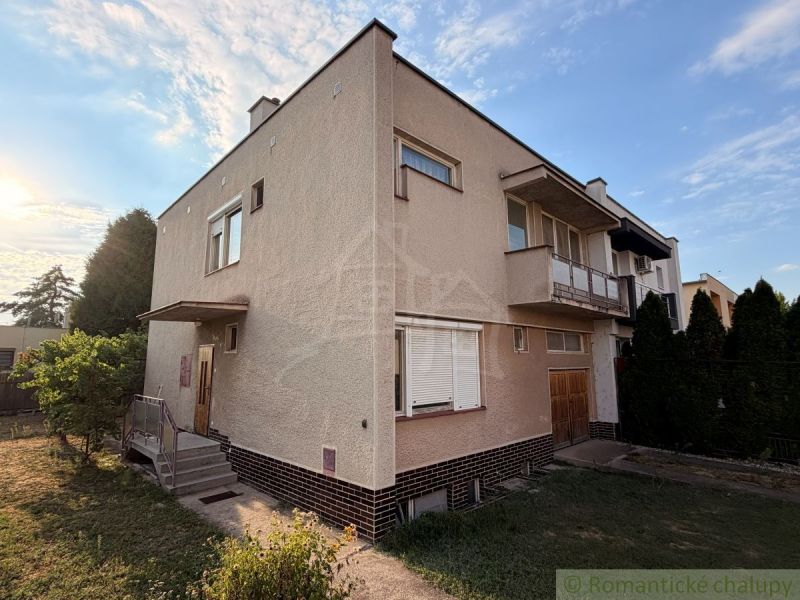 A family house in Nové Zámky with a balcony, garden, and driveway.