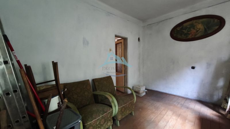 A room in a family house with furniture and a wooden decor floor.