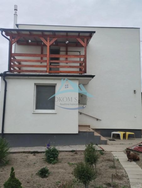 A family house in Bratislava with a balcony and a small garden in a simple style.
