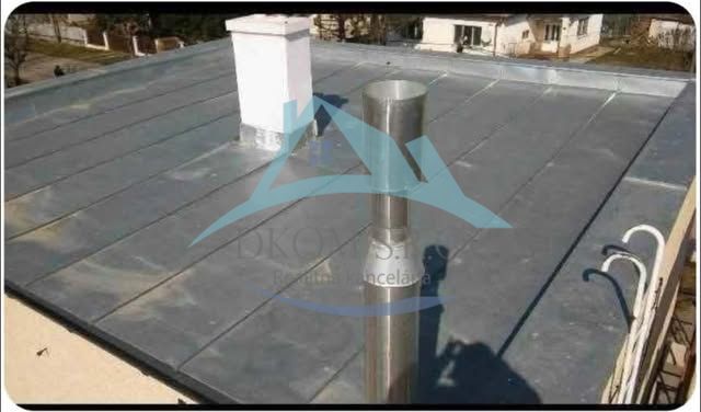 The flat roof of a family house in the town of Soľ shows the chimney and ventilation system.