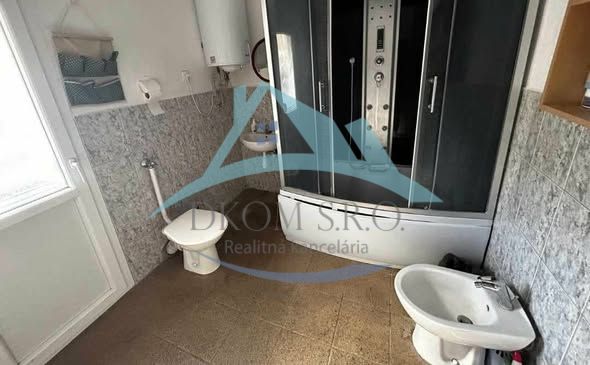 A bathroom in a family house with a modern shower and ceramic tiles.