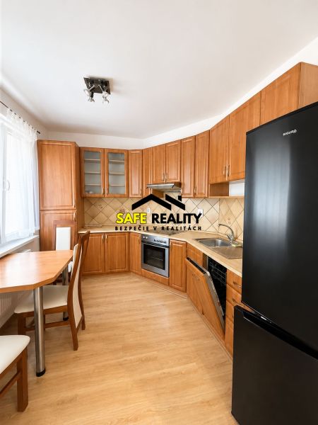 Kitchen in a 3-room apartment with a wooden decor countertop and floor, swivel table.