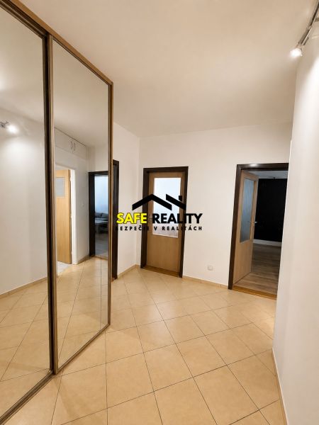 A hallway in a 3-room apartment with a large mirrored wardrobe and tiles.