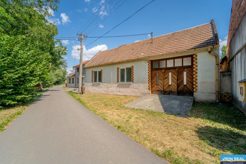 Family house at Vištuk 158 in Vištuk with surroundings and blue sky.