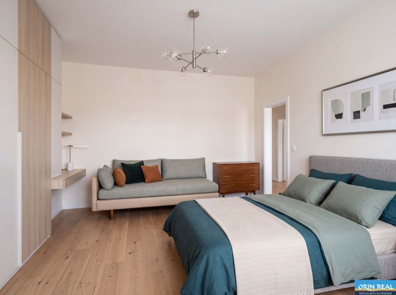 Bedroom in a family house with wood-patterned flooring and comfortable seating.