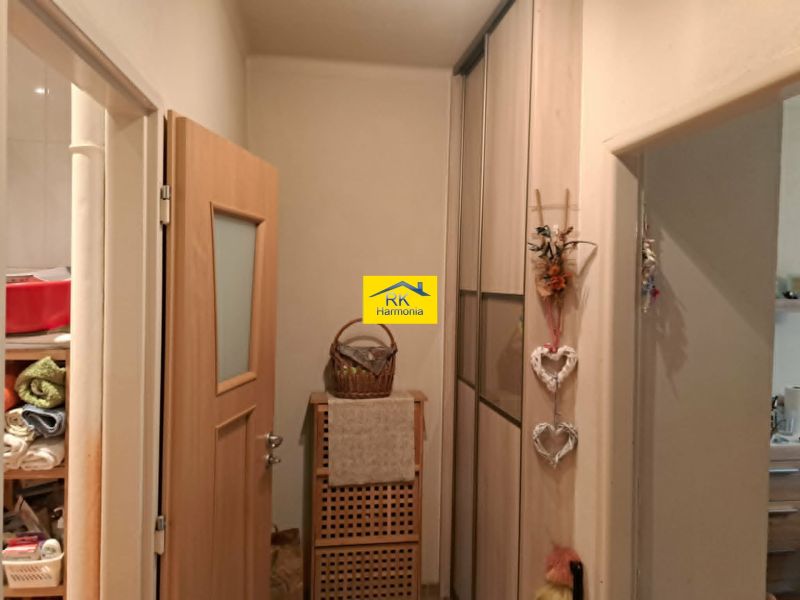 Entrance hallway with storage space in a 2-room apartment, featuring a wooden decor.