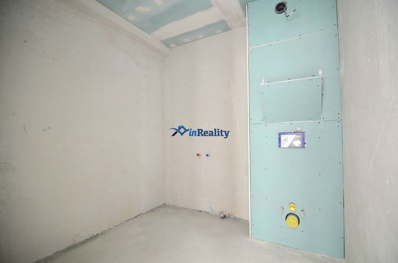 A construction room in a 3-room apartment with preparation for sanitary installation.