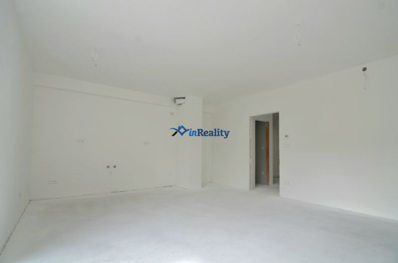 A neutrally toned interior of a 3-room apartment, white wall, preparation for a kitchen unit.