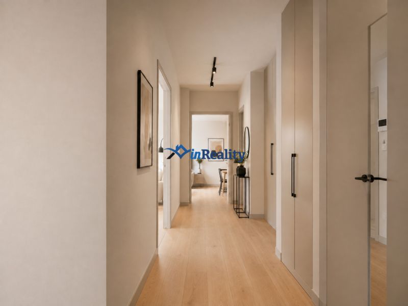 A hallway in a 3-room apartment with a wooden decor floor and modern furniture.