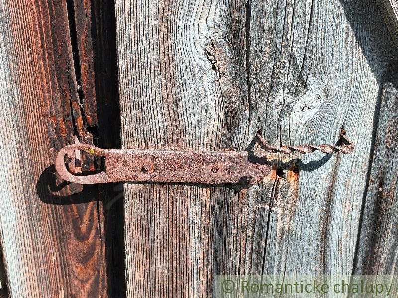 An old wooden fence with a metal latch in Pozemky - housing in Nižné Repaše.