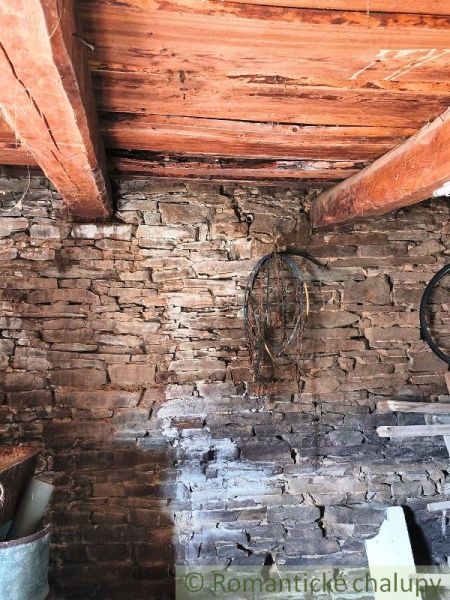 Stone wall and wooden ceiling in the interior, Land - housing.