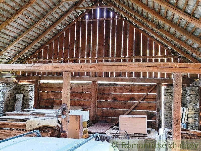 Wooden interior structure, suitable for residential plots, with stored materials.
