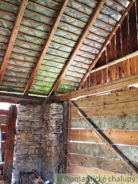 Wooden interior with a stone wall in a house on the property - living.