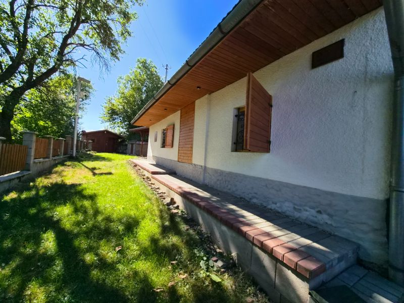 A family house in Mikušovce with shutters and nearby natural surroundings.