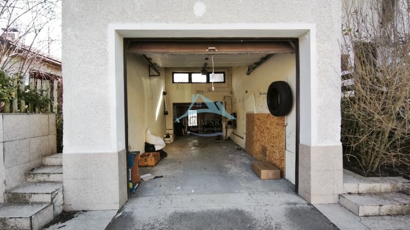 An open garage in a family house on Ľ. Štúra in Veľký Krtíš with several items inside.