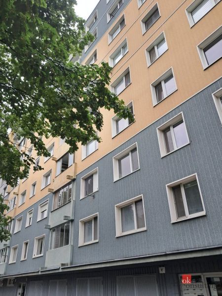 Apartment building on Hlavná Street in Stupava, with trees in the foreground.