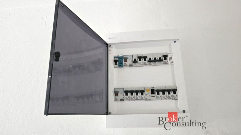 An electrical distribution box in a 4-room apartment with open circuit breakers.