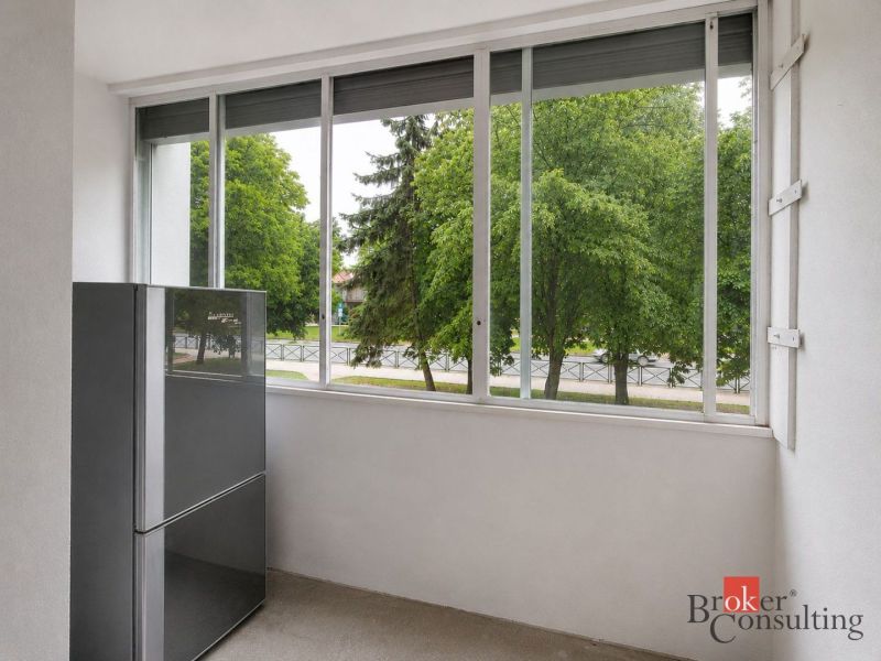 Glazed loggia with greenery outside the window in a 4-room apartment.