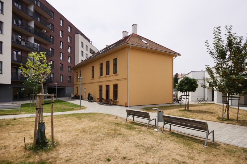 Renovated building with a courtyard and benches on Továrenská Street in Košice, Old Town district.