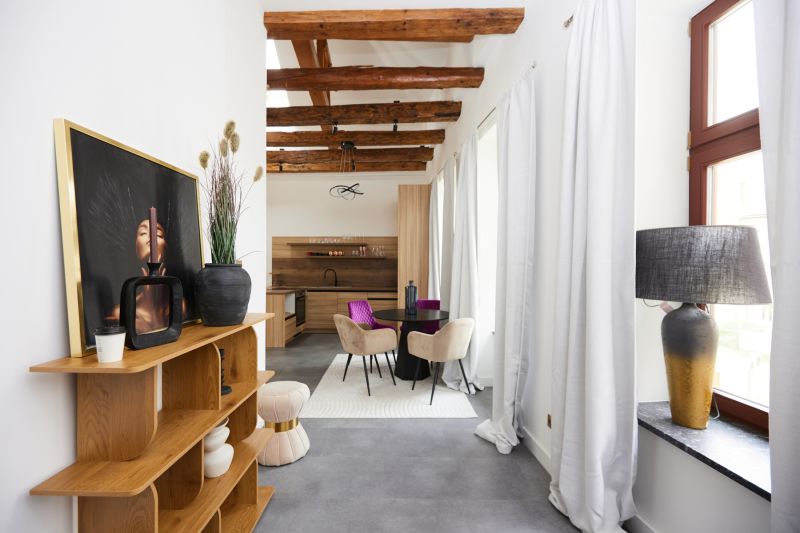 Living space of a 3-room apartment with wooden beams and decorative furniture.