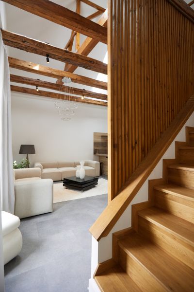 A staircase with a wooden decor floor leading to the living room in a 3-room apartment.