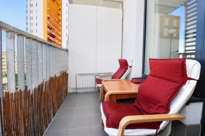 The balcony of a 2-room apartment with two chairs and a table on Jégého Street in Bratislava.