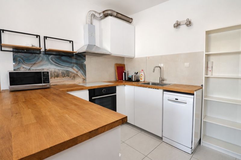 A kitchen in a 2-room apartment with a wooden decor and modern design.