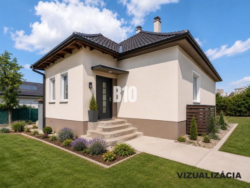 A family house in Nitra with a garden, lawn, and ornamental plants under a blue sky.