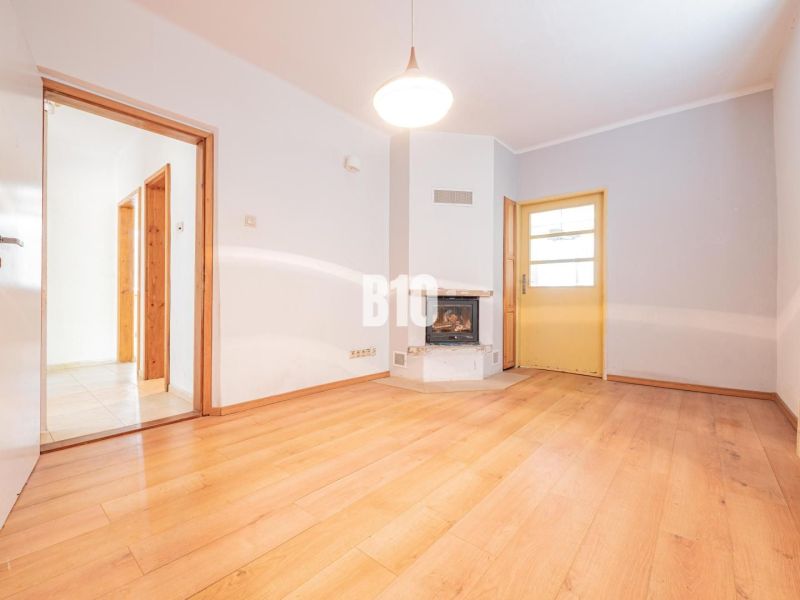 Interior of a family house with a wooden decor floor and a fireplace.
