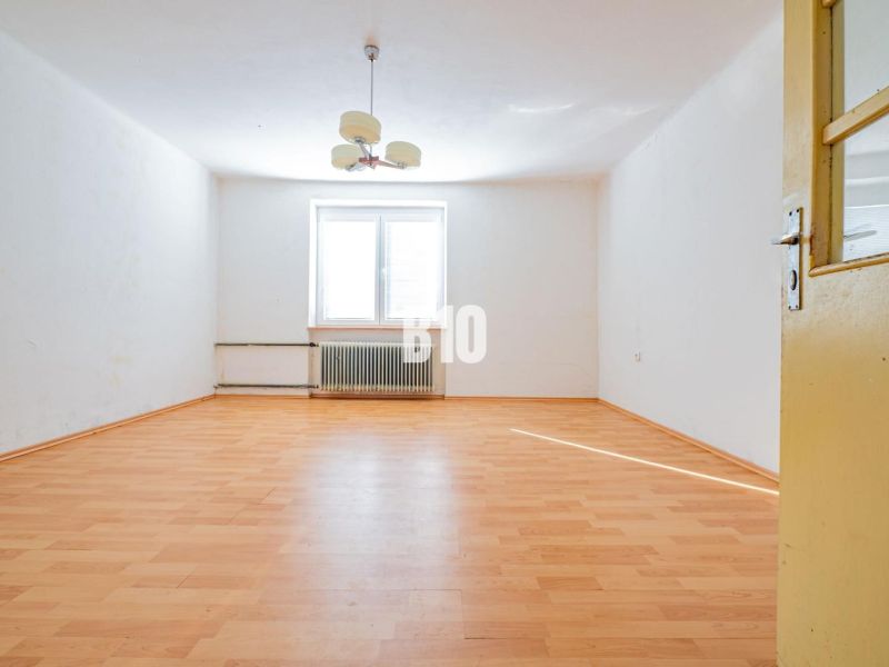 Interior of a family house with a wooden decor floor and white walls.