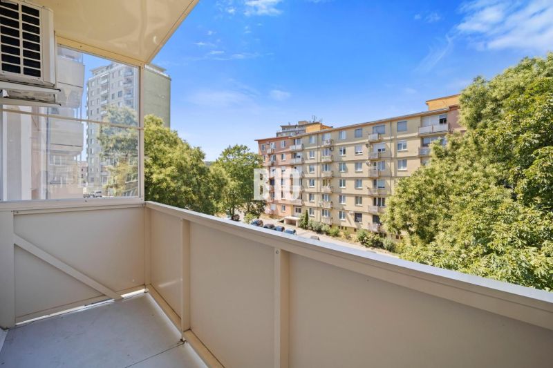 The view from the balcony of a three-room apartment in Nitra overlooking the housing estate and trees.