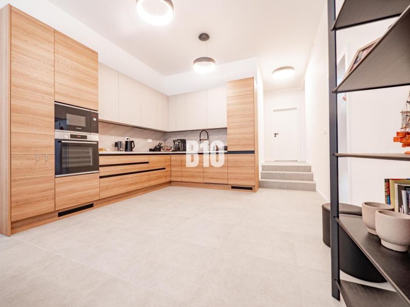 A kitchen in a family house with wooden decor and white walls.