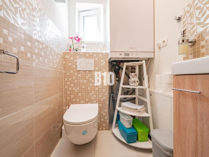 A bathroom in a family house with tiles and modern equipment.