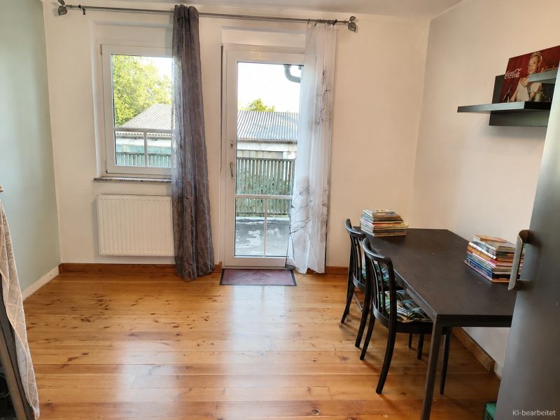 Interior of a family house with a wood-decor floor, table, books, and a plastic entrance.