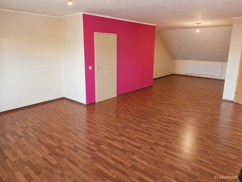 Living room in a family house with a wooden decor floor and a pink wall.