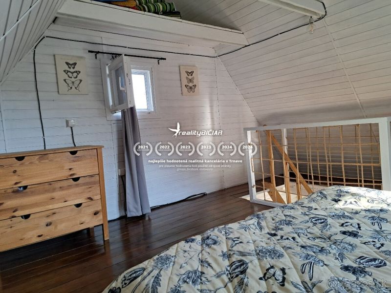 Interior of a cabin with a bed and a cabinet, floor with wooden decor.