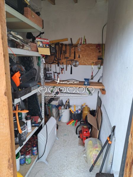 Tools and equipment in the utility room of the cabin with a wooden decor floor.